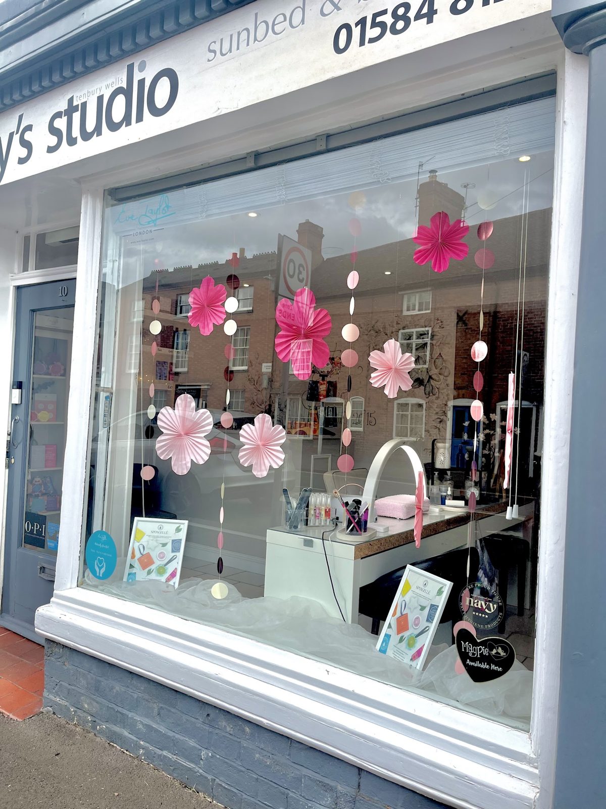 The Shorty's Studio shopfront on Cross Street, with pink paper flowers in the window